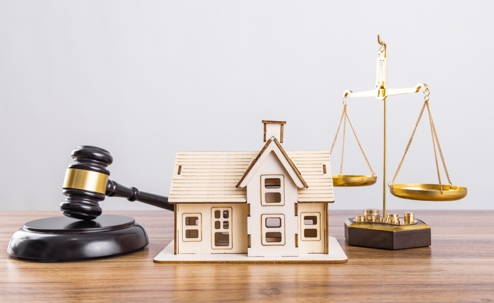 gavel, scales, and house model