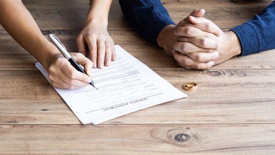 couple signing divorce papers
