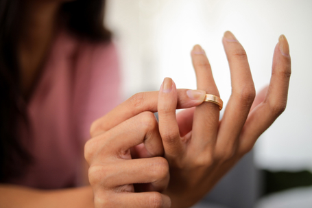 woman removing wedding ring