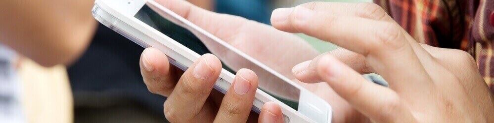 Contact a Divorce Lawyer in Westchester County, NY Young Woman Using an iPhone Smartphone to Contact a Divorce Attorney